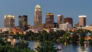Austin skyline at dusk with illuminated hotels and river.
