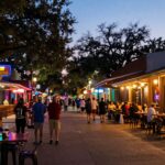 Austin neighborhood street with bars and restaurants at night.